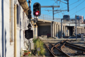 Red railway signal illustrating the stop signal passed by a Porirua passenger train at Plimmerton.