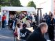 Visitors gather beside a food truck and outdoor tables at Porirua’s Bloody Good Night Market.