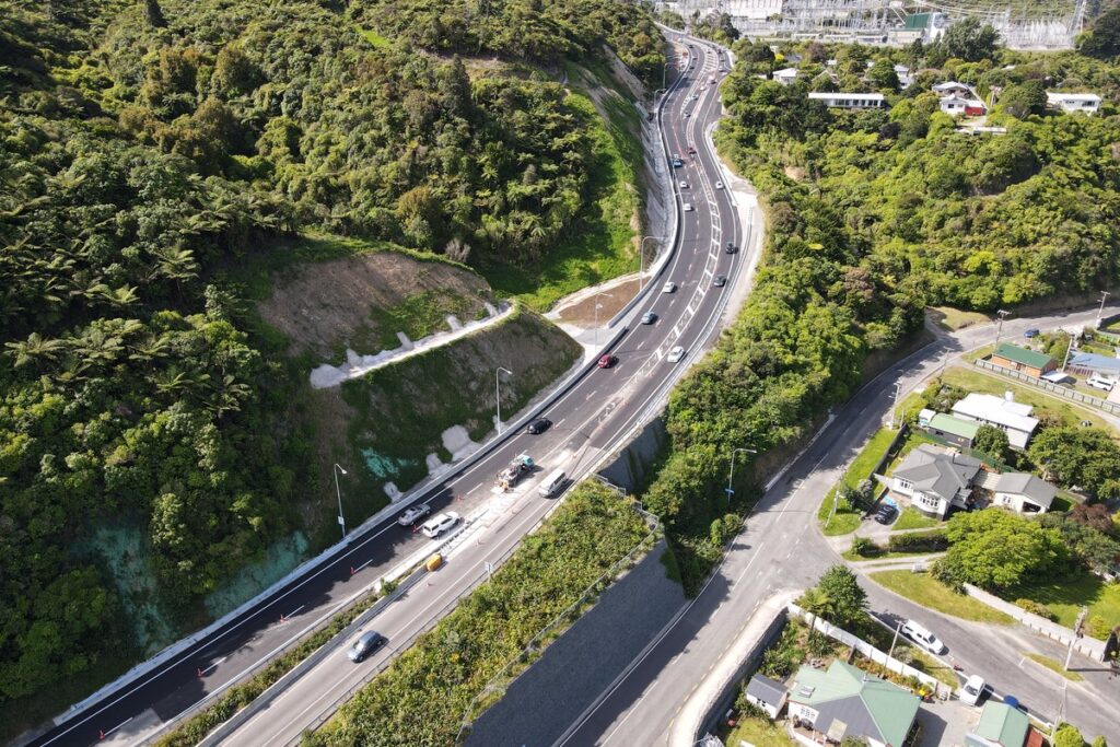 Aerial view of State Highway 58 on Haywards Hill beside bush-covered slopes and the electricity substation.