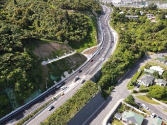 Aerial view of State Highway 58 on Haywards Hill beside bush-covered slopes and the electricity substation.